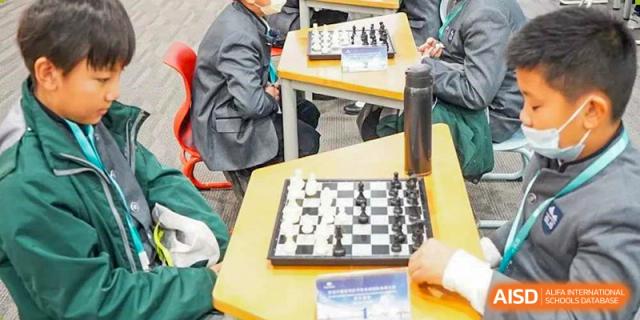 A close-up of a chess board with pieces on a table in a classroom at Shenzhen Foreign Languages GBA Academy.