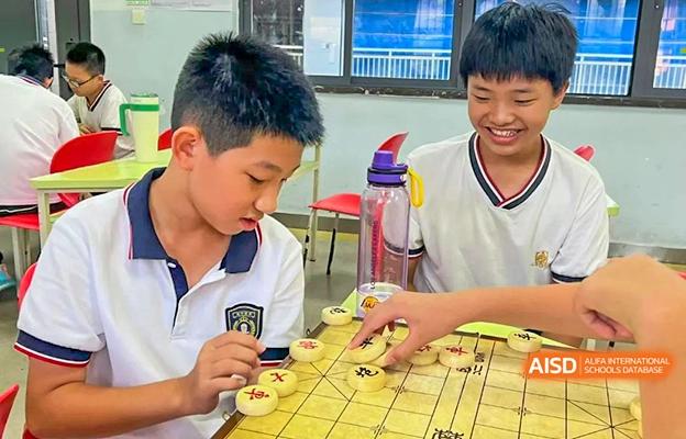 Two students from Shenzhen Foreign Languages GBA Academy playing a game of Xiangqi, or Chinese chess.