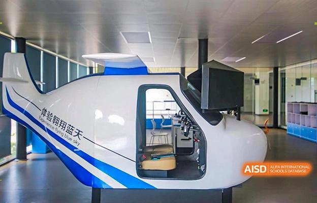 A close-up of a high-tech model, likely a train or plane cockpit, used for educational purposes at Shenzhen Foreign Languages GBA Academy.