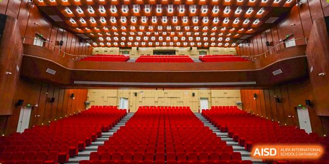 Rows of empty red seats in a theater or auditorium at Shenzhen Foreign Languages GBA Academy.