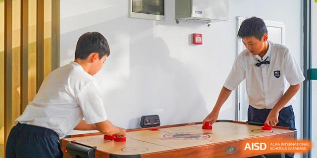 A student at Shenzhen Foreign Languages GBA Academy working on a hands-on project at a table.