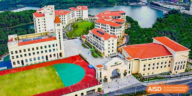 An aerial view of the running track and main building at Shenzhen Foreign Languages GBA Academy.