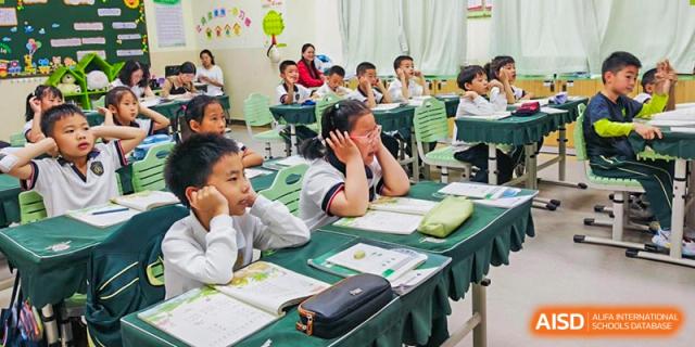 A classroom of students from Maple Leaf International Academy Shenzhen is listening to a teacher during a lesson.