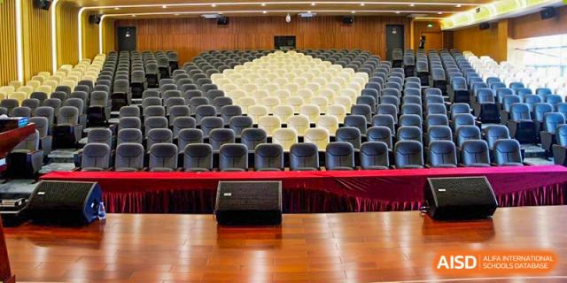 A view of the stage and empty seating area in the auditorium at Maple Leaf International Academy Shenzhen.