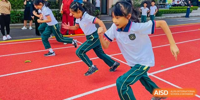 A close-up shot of students from Maple Leaf International Academy Shenzhen as they run a race on an outdoor track.