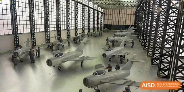 A detailed display of miniature model airplanes in a large hall at HuZ Deutsche Schule Shenyang.