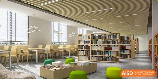 A view of the modern library at Overseas Chinese Academy of Chiway Suzhou, with bookshelves and a comfortable seating area.