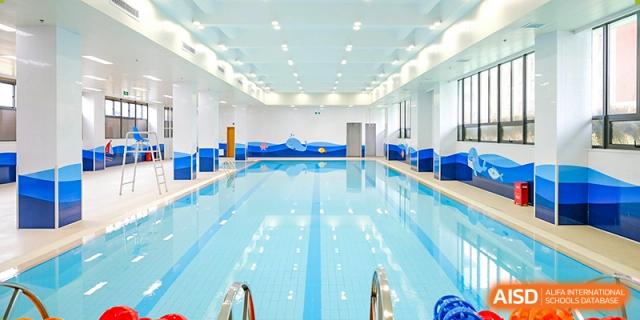 A large, indoor swimming pool at Overseas Chinese Academy of Chiway Suzhou.