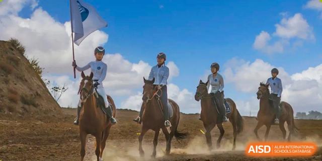 Students riding horses outdoors as an extracurricular activity at Shanxi Plinth International School.