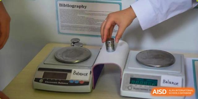 A balance scale being used in a science or physics lab at Wuxi Boston International School.