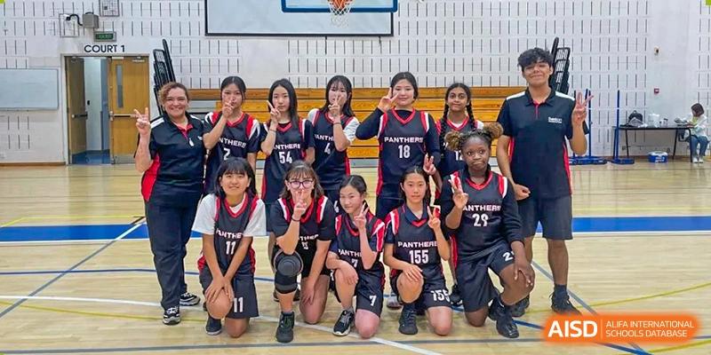 A girls' volleyball or sports team posing together at Wuxi Boston International School.
