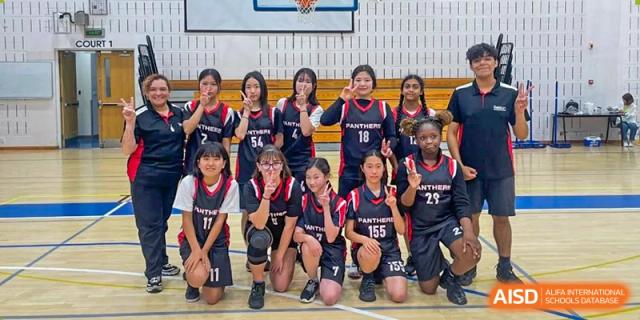 A girls' volleyball or sports team posing together at Wuxi Boston International School.