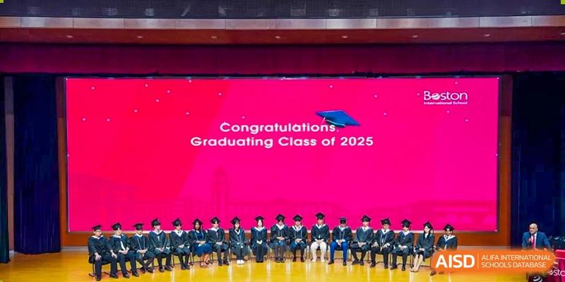 Graduating Class of 2025 students posing on a stage at Wuxi Boston International School.
