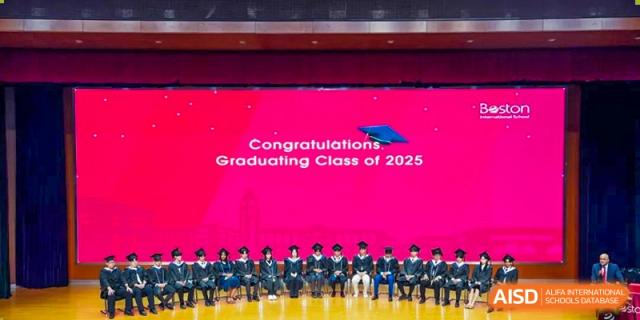 Graduating Class of 2025 students posing on a stage at Wuxi Boston International School.