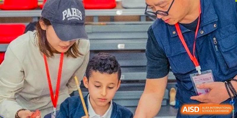 Young male student concentrating intently during an activity at Wuxi Boston International School.