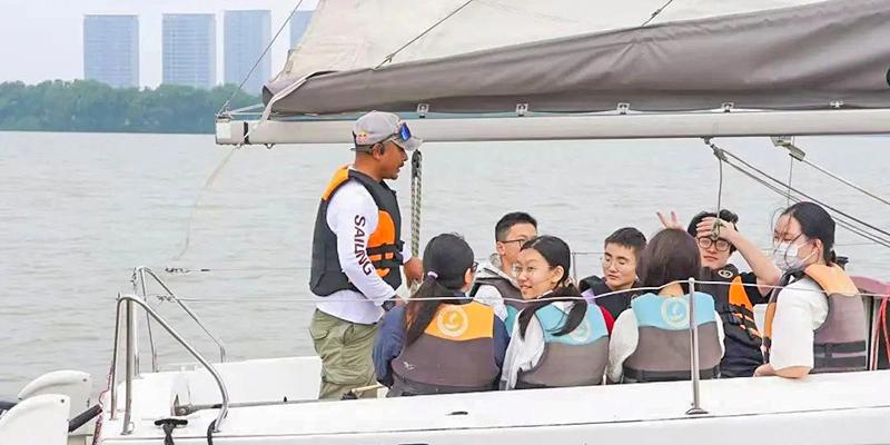 Students wearing life vests on a boat with an instructor at Wuxi Boston International School.