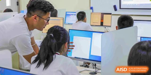 Students work on desktop computers in a technology or IT class at Wuhan Britain-China School.