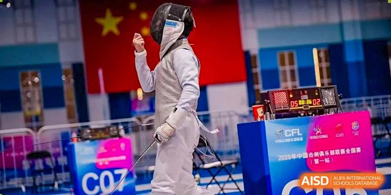 A student from Wuhan Britain-China School in full protective gear, posing with an epee while participating in a fencing competition.