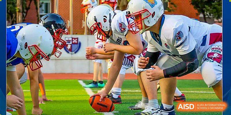 Students from Wuhan Britain-China School lined up on the field, ready to start a game of American football.