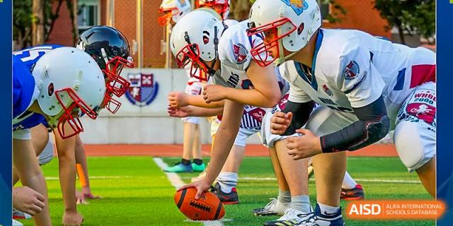 Students from Wuhan Britain-China School lined up on the field, ready to start a game of American football.