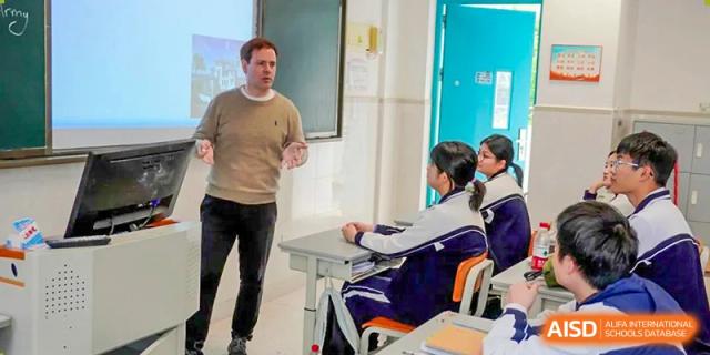 A foreign teacher giving a lecture to students seated in a classroom at Shenzhen Third Senior High School International Division A-Level Class.