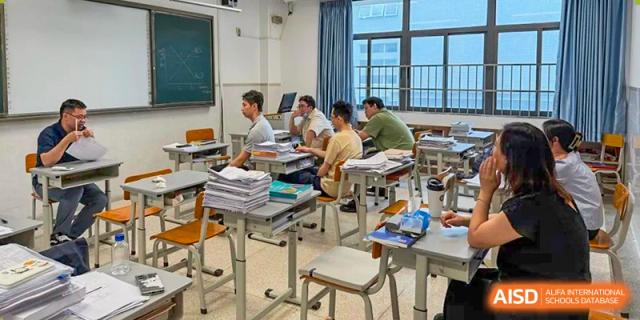 Students studying and working at their desks in a classroom at Shenzhen Third Senior High School International Division A-Level Class.