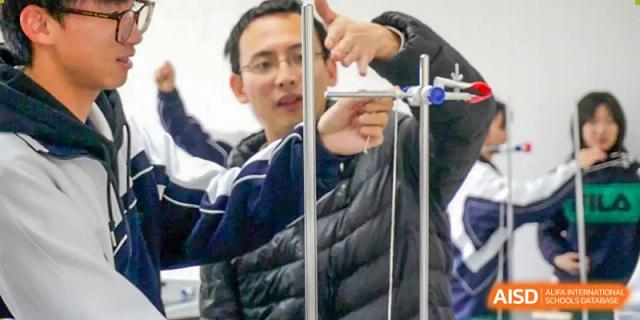 Close-up of students collaborating on a hands-on technical project or experiment at Shenzhen Third Senior High School International Division A-Level Class.