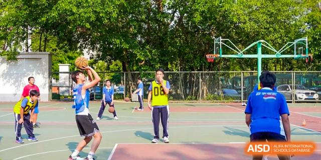 Student wearing a yellow sports vest on an outdoor basketball court at Shenzhen Third Senior High School International Division A-Level Class.
