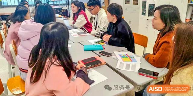 Students collaborating or working on an academic task at a table at Shenzhen Third Senior High School International Division A-Level Class.