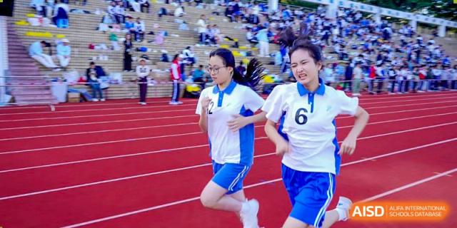 Students running a race on the track during a sports day event at Shenzhen Third Senior High School International Division A-Level Class.