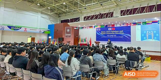 Students attending a formal school assembly or event in an auditorium at Weihai Zhongshi Foreign School (WZFS).