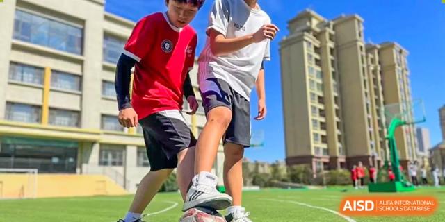 Close-up of students' legs and feet during an outdoor sports activity or competition at Weihai Zhongshi Foreign School (WZFS).