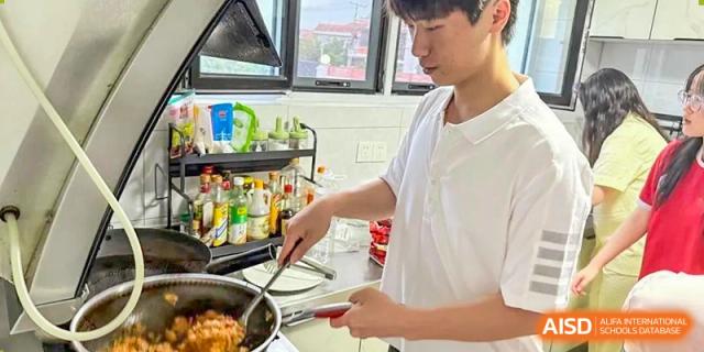 A student cooking or preparing food in a kitchen during a health and nutrition class at Weihai Zhongshi Foreign School (WZFS).