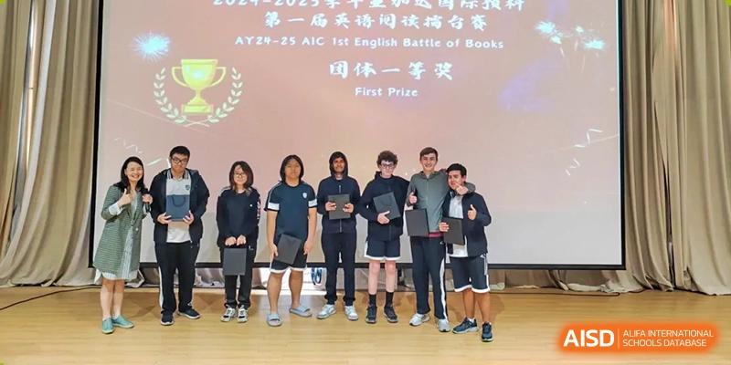 A group of students from a basketball team posing with their 'First Prize' award at Alcanta International College.