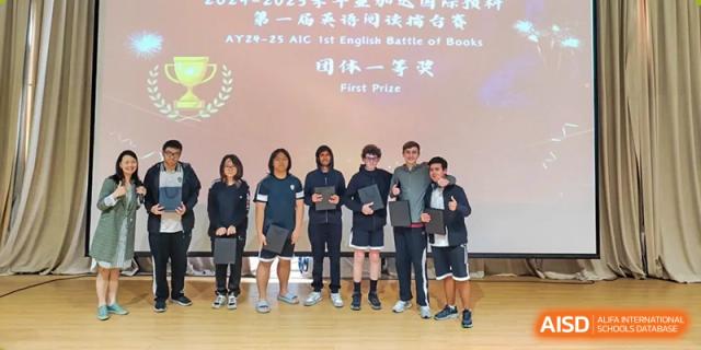 A group of students from a basketball team posing with their 'First Prize' award at Alcanta International College.