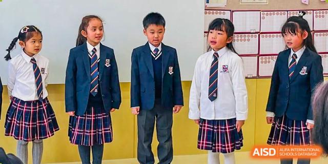 Three students from Changsha BeeMee Forest School (CBFS) standing side-by-side in their formal school uniforms.