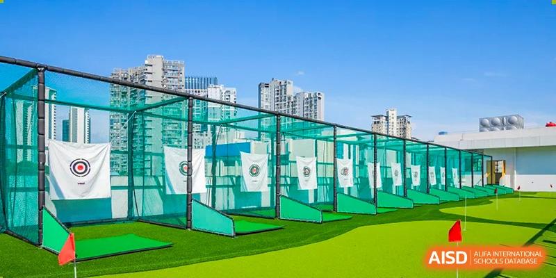 The outdoor golf practice cages and green turf area at Changsha BeeMee Forest School (CBFS), surrounded by netting.