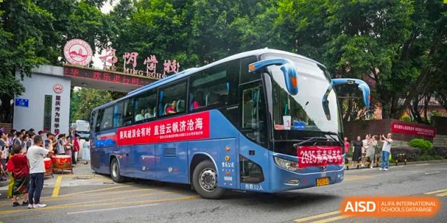 CHONGQING WEIMING SCHOOL branded school bus parked outside, ready for a student trip or event.