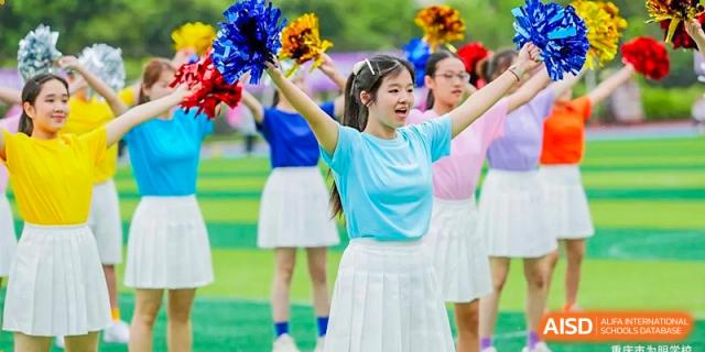 CHONGQING WEIMING SCHOOL cheerleaders cheering and holding pom-poms during a sports event or school activity.