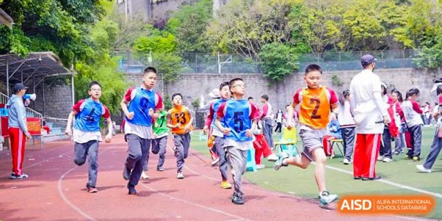 CHONGQING WEIMING SCHOOL students participating in a running race or dash during a sports day event.