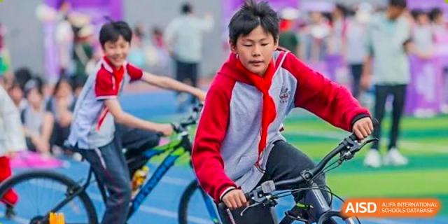 A CHONGQING WEIMING SCHOOL student riding a bicycle during a sporting event or activity.