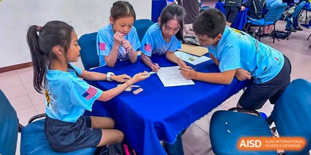 Students from Dulwich College Shanghai Puxi working together on a project.
