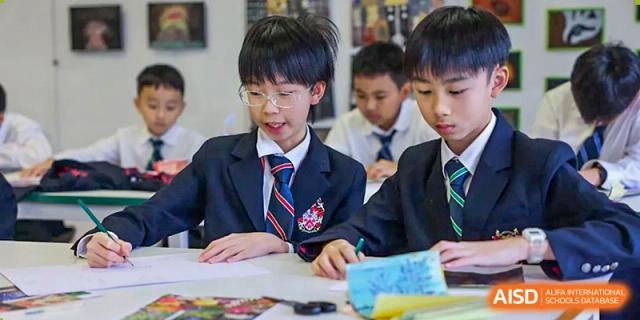Students from Dulwich College Shanghai Puxi working in a classroom.
