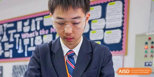 A student from Dulwich College Shanghai Puxi wearing safety glasses in a science class.
