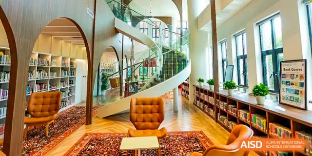 The library at Dulwich College Shanghai Puxi with a spiral staircase.