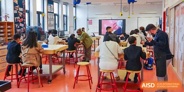 Students from Dulwich College Shanghai Puxi working on a project in a classroom.