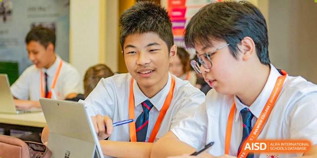 Two students from Dulwich College Shanghai Puxi smiling while working together in class.