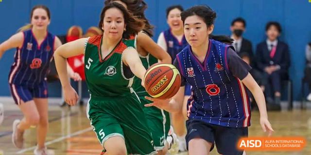 Two students from Dulwich College Shanghai Puxi playing basketball.