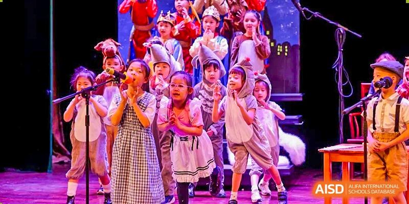 Young students from Dulwich College Shanghai Puxi performing on stage.
