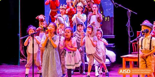 Young students from Dulwich College Shanghai Puxi performing on stage.
